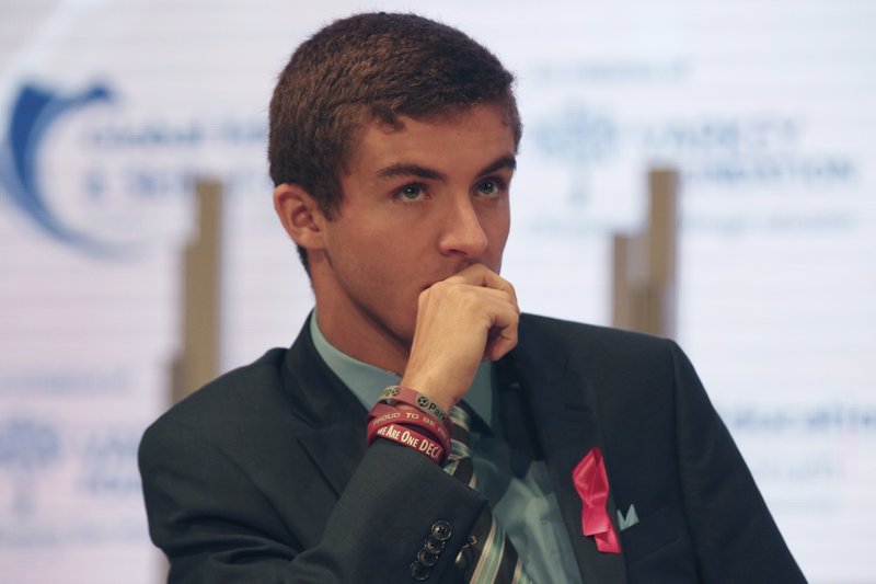 Parkland High School student Lewis Mizen listens on stage at the Global Education and Skills Forum in Dubai, United Arab Emirates, Saturday, March 17, 2018. Student survivors of a Florida high school shooting took their message calling for greater gun safety measures abroad for the first time on Saturday, sharing with educational professionals from around the world their frightening experience. (AP Photo/Jon Gambrell)