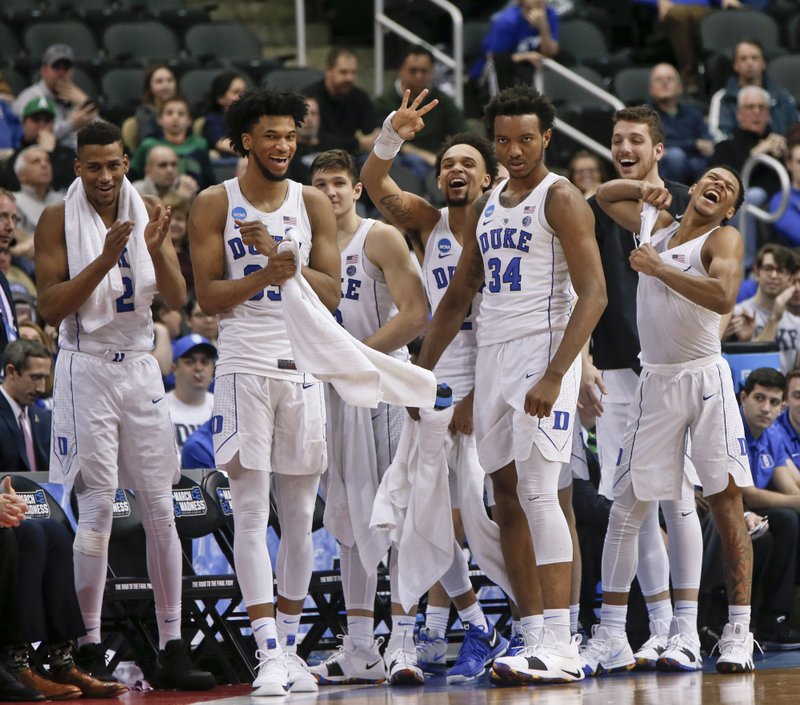 The Duke team celebrates as time runs down during the second half as they defeat Rhode Island in a second-round game in the NCAA men's college basketball tournament, Saturday, March 17, 2018, in Pittsburgh. Duke won 87-62. (AP Photo/Keith Srakocic)