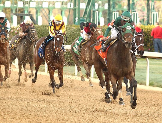 Jockey Paco Lopez rides Martini Glass across the wire to win the Azeri Stakes at Oaklawn Park Saturday March 17, 2018. (The Sentinel-Record/Richard Rasmussen) 