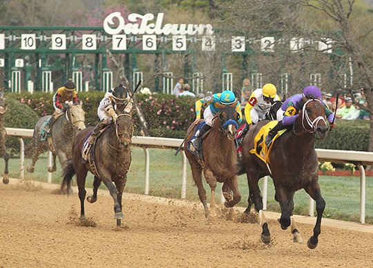 Jockey Luis Saez leads the pack in deep stretch Magnum Moon(4), en route to winning the Rebel Stakes at Oaklawn Park Saturday March 17, 2018. (The Sentinel-Record/Richard Rasmussen) 