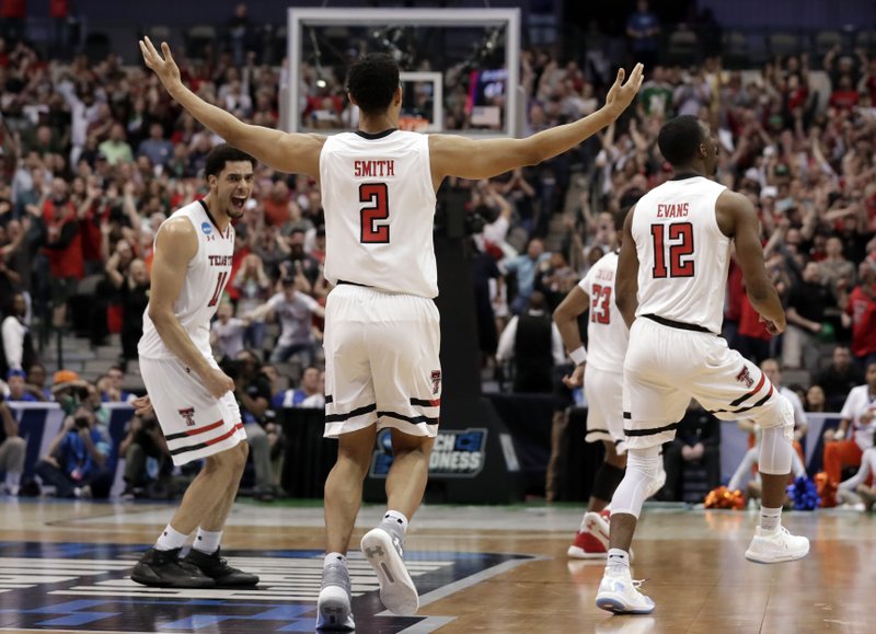 Texas Tech's Zach Smith (11), Zhaire Smith (2) and Keenan Evans (12), celebrate in the closing seconds of the second half of a second-round game against Florida at the NCAA men's college basketball tournament in Dallas, Saturday, March 17, 2018. Texas Tech won 69-66. (AP Photo/Tony Gutierrez)