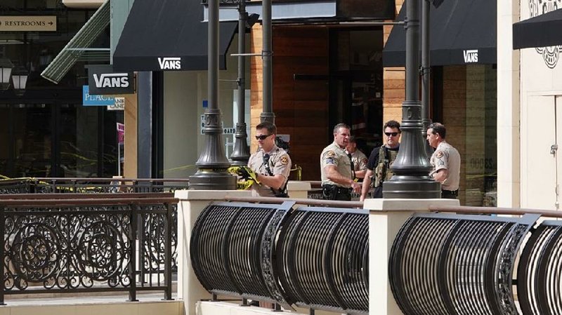 Officers work after a shooting Saturday at The Oaks mall in Thousand Oaks, Calif.