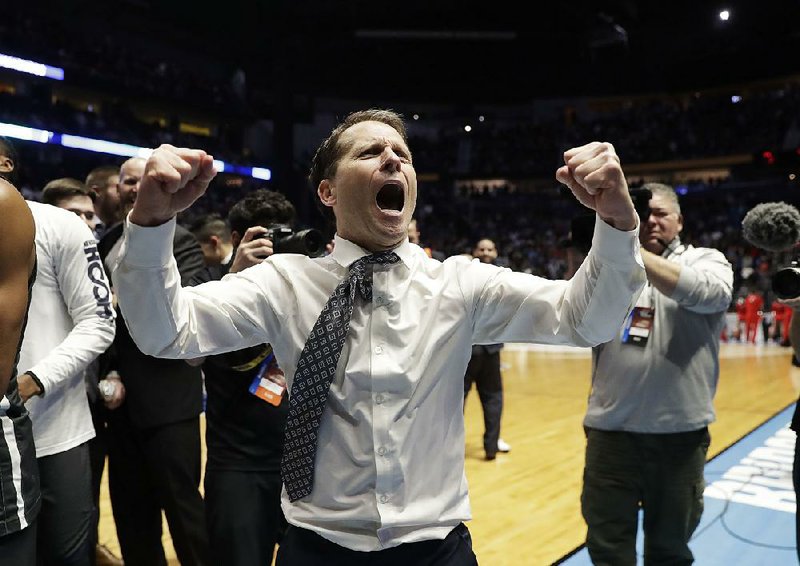 Nevada Coach Eric Musselman celebrates after his team overcame a 22-point deficit to beat Cincinnati 75-73 in the NCAA Tournament on Sunday in Nashville, Tenn.