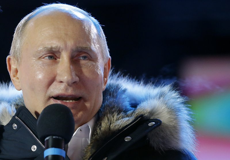 Russian President Vladimir Putin speaks to supporters during a rally near the Kremlin in Moscow, Sunday, March 18, 2018. An exit poll suggests that Vladimir Putin has handily won a fourth term as Russia's president, adding six more years in the Kremlin for the man who has led the world's largest country for all of the 21st century. (AP Photo/Alexander Zemlianichenko)