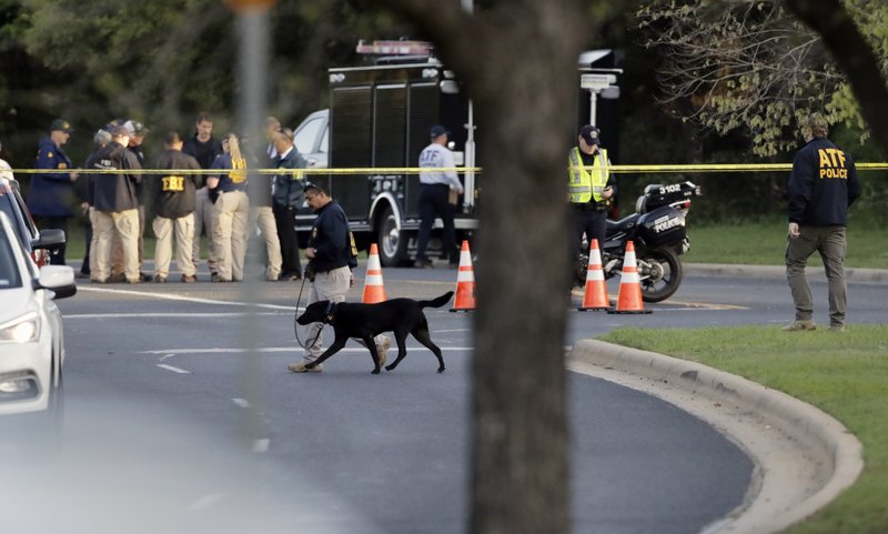 Associated Press/Eric Gay Officials work and stage near the site of Sunday's deadly explosion this morning in Austin, Texas. Police warned nearby residents to remain indoors overnight as investigators looked for possible links to other package bombings elsewhere in the city this month.