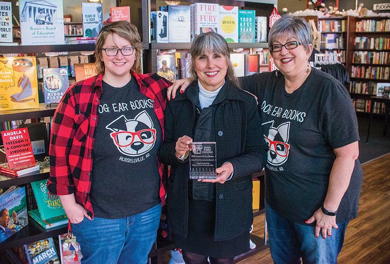 Main Street Arkansas recognized Dog Ear Books recently with the Best Downtown Retail Award. Betsy McGuire, executive director of Main Street Russellville, center, celebrates with Dog Ear Books owners Emily Young, left, and her mother, Pat Young, right.