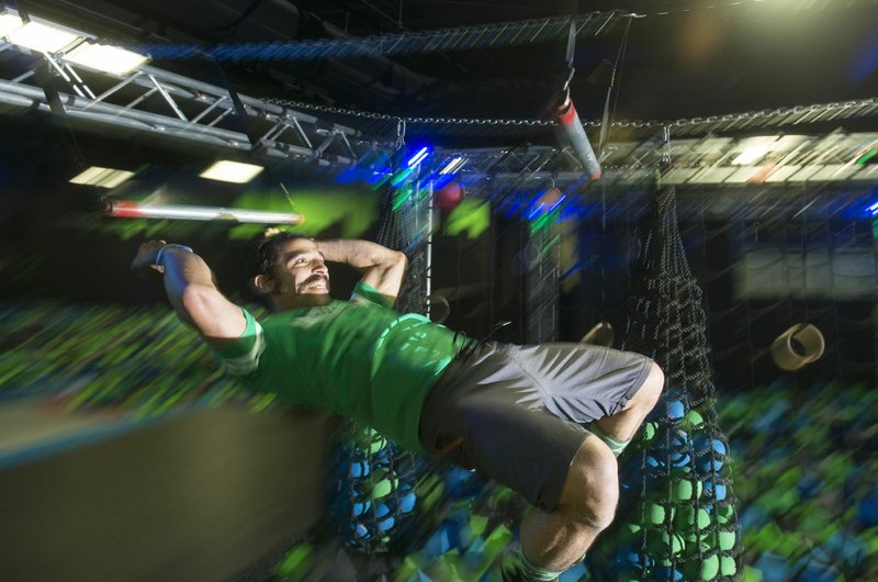 NWA Democrat-Gazette/BEN GOFF @NWABENGOFF Jeff Harris trains Friday, March 9, 2018, at High Rise Extreme Air Sports in Rogers. Harris, a former Bentonville firefighter, now owns his own waste and recycling business, White Line Waste, while still serving as a volunteer firefighter in Centerton. He is training to compete on the television show American Ninja Warrior.