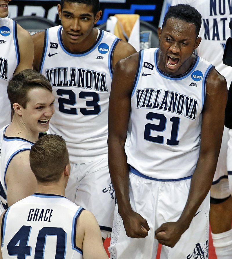 The Associated Press NEW FAVORITES: Villanova's Dhamir Cosby-Roundtree (21) celebrates with Denny Grace (40) after the Wildcats' 81-58 elimination of Alabama in the NCAA Tournament in Pittsburgh on Saturday. Villanova is the tournament's new favorite after other top seeds were eliminated in the opening weekend.