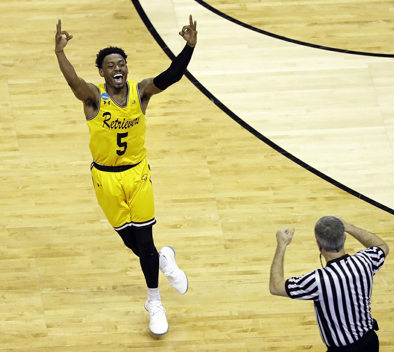 The Associated Press GOLDEN RETRIEVERS: UMBC's Jourdan Grant celebrates after a basket against Virginia Friday during the Retrievers' historic 74-54 upset in Charlotte, N.C., to become the first 16-seed to ever defeat a No. 1 seed in the men's NCAA Tournament. The upset scored about $1.7 million for the America East Conference.