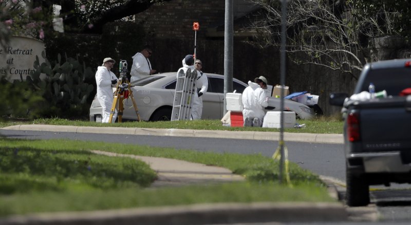 The Associated Press EXPLOSION SITE: Federal investigators work near the site of Sunday's explosion, Monday, in Austin, Texas. Multiple people were injured in the explosion Sunday night, and police warned nearby residents to remain indoors overnight as investigators looked for possible links to other package bombings elsewhere in the city this month.