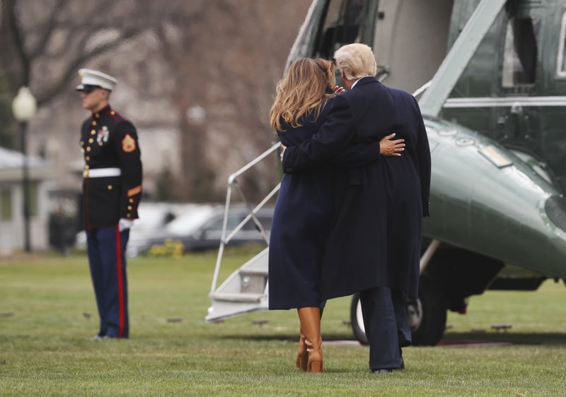 President Donald Trump holds first lady Melania Trump who lost her footing while walking across the South Lawn of the White in Washington, Monday, March 19, 2018, before boarding Marine One helicopter for the short trip to Andrews Air Force Base, Md. Trump is traveling to Manchester, N.H., to announced his plan to combat opioid drug addiction. (AP Photo/Pablo Martinez Monsivais)
