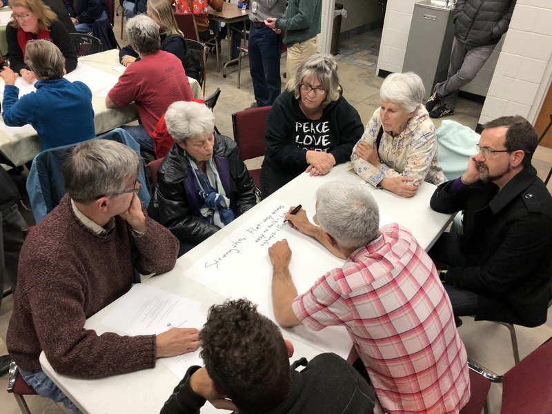 NWA Democrat-Gazette/STACY RYBURN A group of south Fayetteville residents gather Monday around a table to discuss the strengths, weaknesses, opportunities and threats in their neighborhood during a community meeting at Christ's Church on 15th Street.