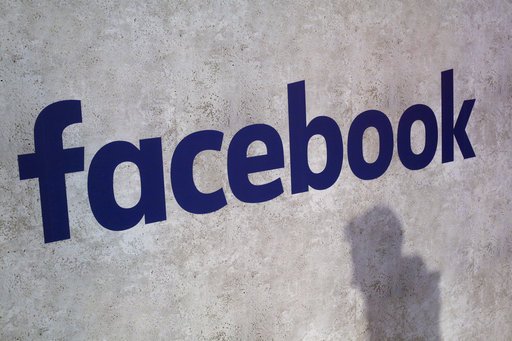 File - This Jan. 17, 2017, file photo shows a Facebook logo being displayed in a start-up companies gathering at Paris' Station F, in Paris. A former employee of a Trump-affiliated data-mining firm says it used algorithms that &quot;took fake news to the next level&quot; using data inappropriately obtained from Facebook. (AP Photo/Thibault Camus, File)