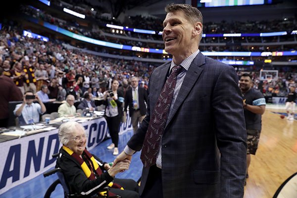 Sister Jean Dolores Schmidt, left, greets Loyola-Chicago coach Porter Moser after the team's 63-62 win over Tennessee in a second-round game at the NCAA men's college basketball tournament in Dallas, Saturday, March 17, 2018. (AP Photo/Tony Gutierrez)

