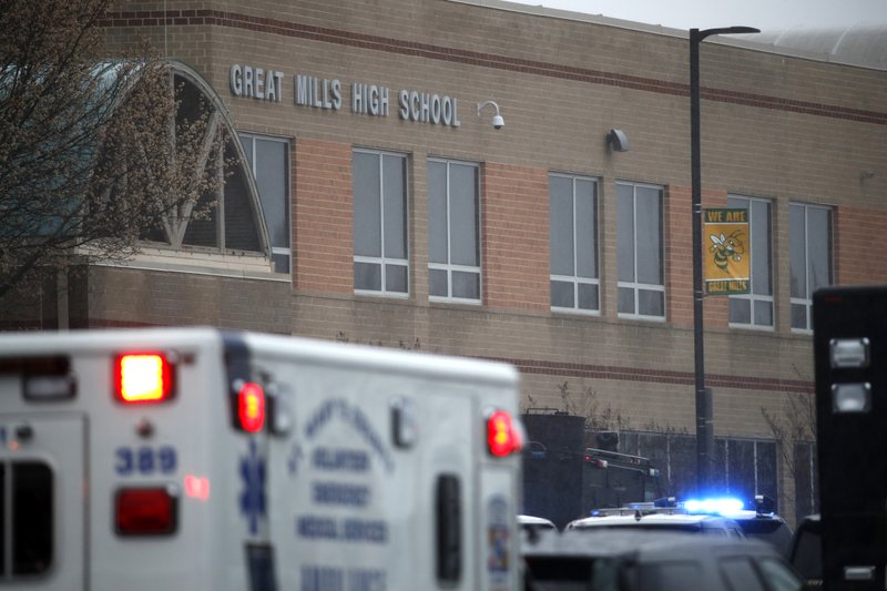 Deputies, federal agents and rescue personnel, converge on Great Mills High School, the scene of a shooting, Tuesday morning, March 20, 2018 in Great Mills, Md. The shooting left at least three people injured including the shooter. (AP Photo/Alex Brandon )

