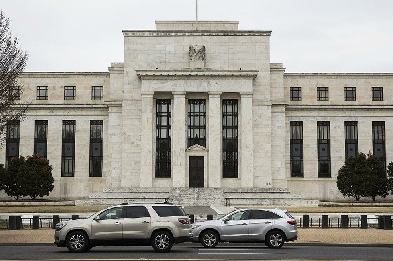 Vehicles pass the Federal Reserve building in Washington, D.C., recently. Although a Senate bill passed last week eases postrecession financial rules, it also gives the Fed more latitude to do “stress-testing” to monitor banks’ stability.  