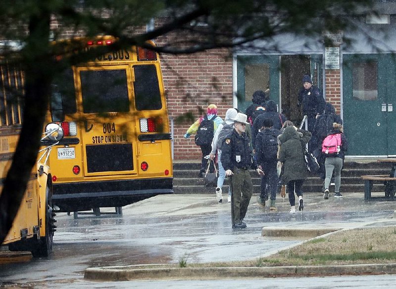 Police escort students Tuesday after a shooting at Great Mills High School in Great Mills, Md.  