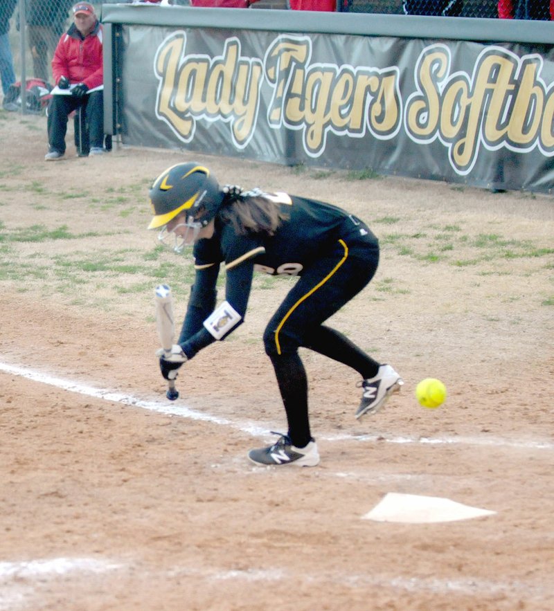 MARK HUMPHREY ENTERPRISE-LEADER Prairie Grove senior Katharine McConnell misses a bunt attempt against Farmington. A high wind affected batting and fielding throughout the contest. Farmington won by run-rule, 20-4, on Tuesday, March 6. The Lady Tigers lost to their other U.S. 62 rival, Lincoln, 10-2, on Tuesday, March 13.