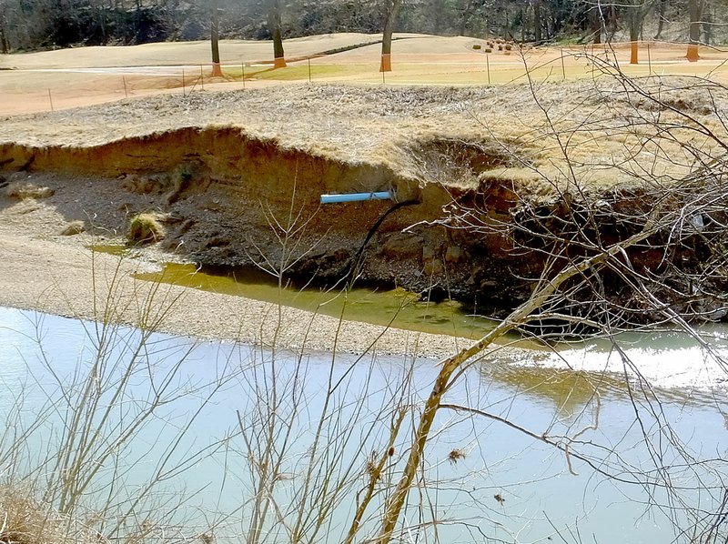 Lynn Atkins/The Weekly Vista Flood waters took a large portion of the bank of Little Sugar Creek where it runs along Highway 71B through Berksdale and then Kingswood Golf Courses.