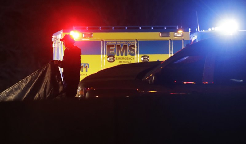 Officials work at the scene where the suspect in a spate of bombing attacks that have terrorized Austin over the past month blew himself up with an explosive device as authorities closed in, the police said early Wednesday, March 21, 2018. (AP Photo/Eric Gay)

