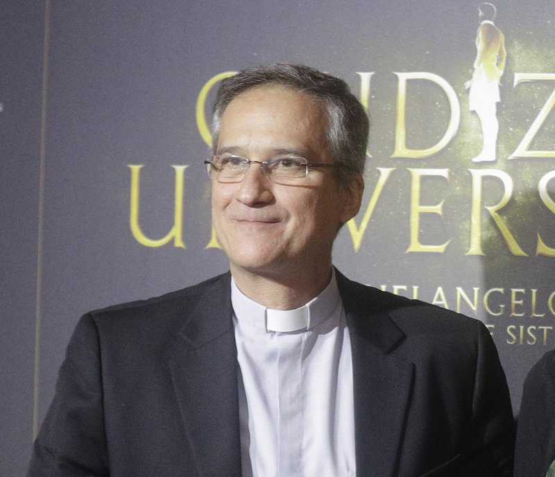 In this March 12, 2018 photo, former head of Vatican communications department Monsignor Dario Vigano poses for a photo call to present the show "Giudizio Universale" (Last Judgement), Michelangelo and the Secrets of the Sistine Chapel, at the Auditorium Conciliazione, in Rome. On Wednesday, March 21, 2018, the Vatican announced that Vigano' had resigned over a scandal about a letter from retired Pope Benedict that he mischaracterized in public and then had digitally manipulated in a photograph sent to the media. 