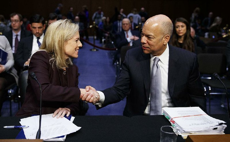 Homeland Security Department Secretary Kirstjen Nielsen and the department’s former secretary, Jeh Johnson, chat Wednesday at the conclusion of a Senate Intelligence Committee hearing on election security.  