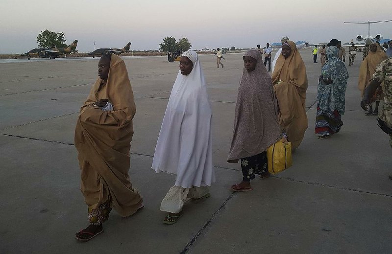 Schoolgirls returned by Boko Haram militants board a military plane Wednesday in Maiduguri, Nigeria.  