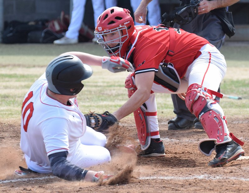 RICK PECK/SPECIAL TO MCDONALD COUNTY PRESS McDonald County catcher Joe Brown tags out a West Plains runner during the Mustangs' 5-1 loss in the Ozarks Classic High School Baseball Tournament in Harrison, Ark.