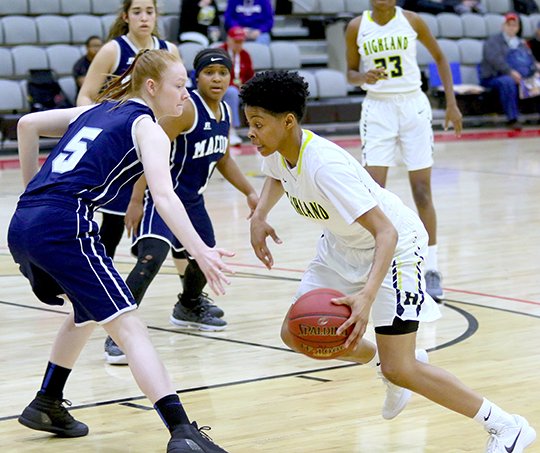 Submitted photo ATTACK THE BASKET: Highland's Berniezha Tidwell, right, dribbles around Macomb defender Ashleigh Ringstad (5) Tuesday during the Scotties' 75-53 win in the opening game of the NJCAA Division II Women's Basketball Championship tournament in Harrison. Photo by Tyler Nordman.