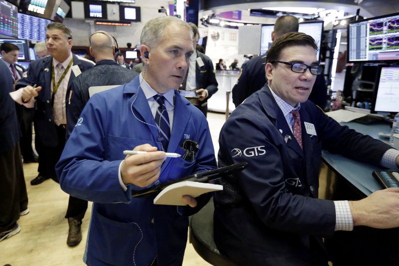 Trader Timothy Nick, center, and specialist Robert Tuccillo, right, work on the floor of the New York Stock Exchange, Wednesday, March 21, 2018. U.S. stocks are mixed Wednesday morning as investors wait for news on interest rates from the Federal Reserve. (AP Photo/Richard Drew)