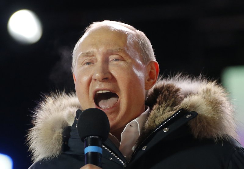 In this March 18, 2018 photo, Russian President Vladimir Putin speaks to supporters during a rally near the Kremlin in Moscow. The tempest over President Donald Trump's congratulatory phone call to Russia's Vladimir Putin is quickly evolving into an uproar over a White House leak about the call. (AP Photo/Alexander Zemlianichenko)