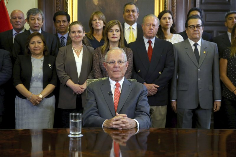 In this handout photo provided by the Peruvian Presidential Press Office, President Pedro Pablo Kuczynski poses with his cabinet before addressing the nation and announcing his resignation from office, Wednesday, March 21, 2018. The embattled Peruvian leader offered his resignation to Congress ahead of a scheduled vote on whether to impeach the former Wall Street investor, according to a presidential aide. 
