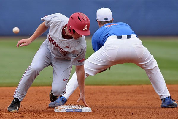 Arkansas shortstop Jax Biggers reaches second base while Florida shortstop Christian Hicks fields a throw during a game Saturday, May 27, 2017, at the SEC Tournament in Hoover, Ala. 