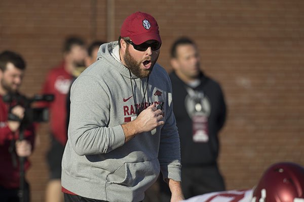 Arkansas offensive line coach Dustin Fry talks to players during practice Thursday, March 1, 2017, in Fayetteville.
