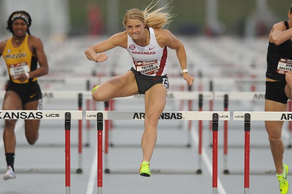 Arkansas' Payton Stumbaugh (center) leads Valerie Thames of Missouri (left) and Alex Gochenour Saturday, April 22, 2017, in the 100-meter hurdles during the John McDonnell Invitational at John McDonnell Field in Fayetteville. 