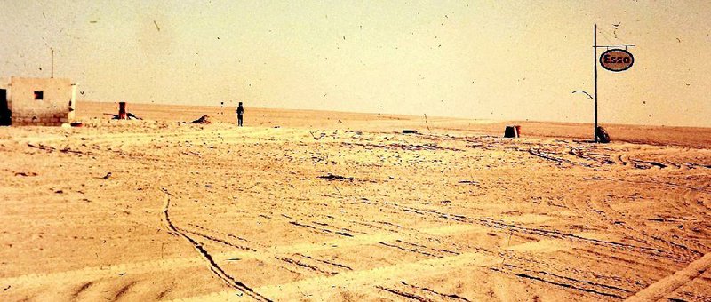 Gasoline is pumped from an oil drum at an Esso gas station 150 miles into the Libyan desert.