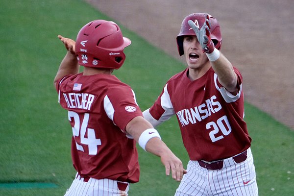 Arkansas second baseman Carson Shaddy (20) congratulates center fielder Dominic Fletcher (24) after Fletcher hit a home run during a game against Florida on Friday, March 23, 2018, in Gainesville, Fla. 