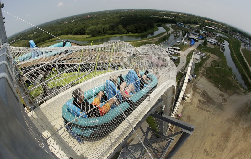 In this July 9, 2014, file photo, riders go down the water slide called "Verruckt" at Schlitterbahn Waterpark in Kansas City, Kan. A former executive with the Kansas water park where a 10-year-old boy died on the giant waterslide has been charged with involuntary manslaughter. Tyler Austin Miles, an operations director for Schlitterbahn, was booked into the Wyandotte County jail Friday, March 23, 2018 and is being held on $50,000 bond. Caleb Schwab died in August 2016 on the 17-story Verruckt water slide at the park in western Kansas City, Kansas. 