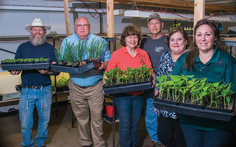 Getting ready for Saturday’s Grant County Master Gardeners’ Spring Workshop and Plant Sale are Forest Klinedinst, from left, Mike Watson, Pat Whiting, Charles Brooks, Nancy Watson and Tab Swaney. The event will begin at 9 a.m., with a workshop set to begin at 9:15, followed by the plant sale at 11 a.m.