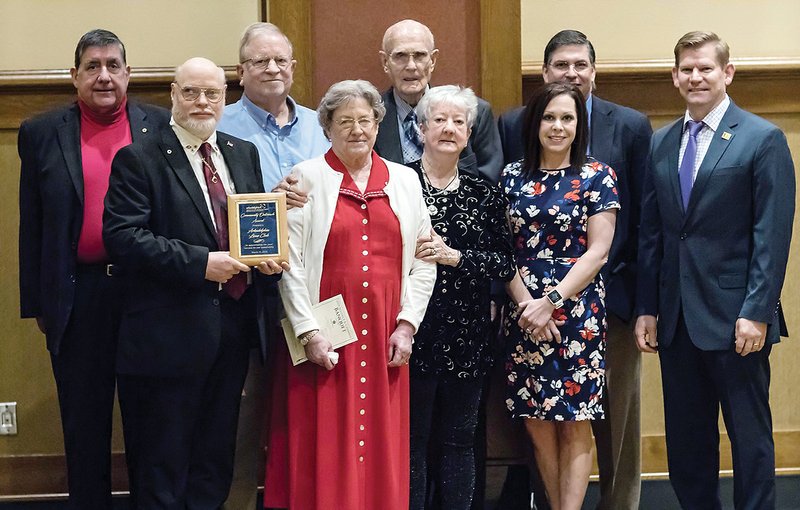The Arkadelphia Lions Club received the Community Outreach Award at the Arkadelphia Alliance and Area Chamber of Commerce’s annual banquet. Accepting the award are, front row, from left, Travis Burton, Anita Williams, Jim Stone and Nicole McGough; and back row, Dennis Williams, Don Roe, Bill Vining, Terry Bird and Mark Overturf.