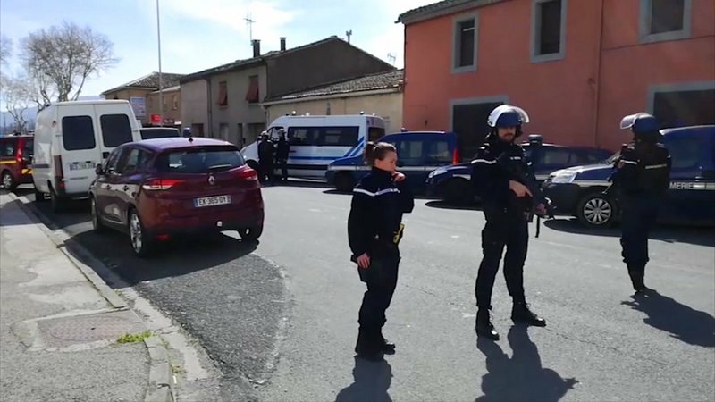 In this image taken from La Depeche Du Midi, police attend an incident in Trebes, southern France, Friday March 23, 2018. French counterterrorism prosecutors are taking charge of the investigation into the shooting of a police officer in southern France that has led to an apparent hostage-taking at a supermarket. 