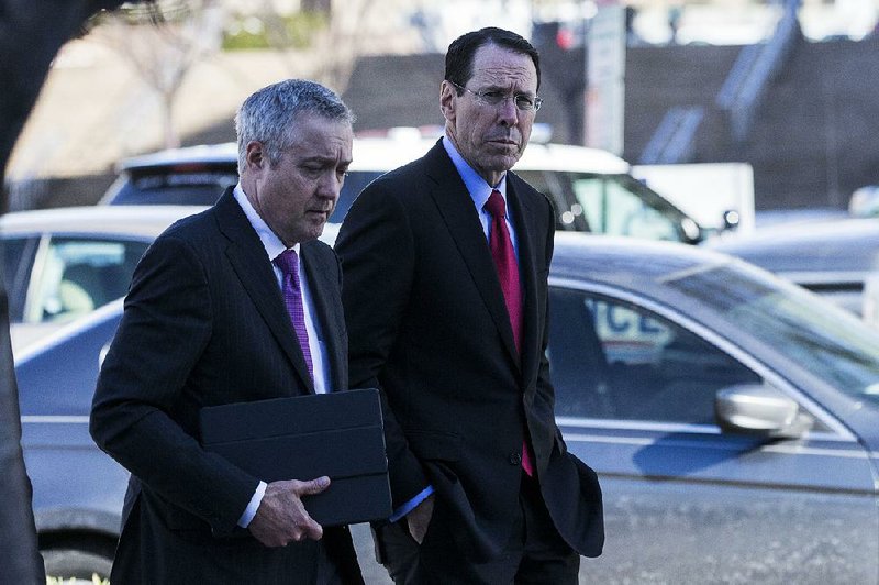 Randall Stephenson (right), chairman and chief executive officer of AT&T Inc., arrives Thursday at federal court in Washington, D.C. Stephenson and Time Warner CEO Jeff Bewkes attended opening arguments in the Justice Department’s lawsuit seeking to block AT&T’s proposed $85 billion acquisition of Time Warner.