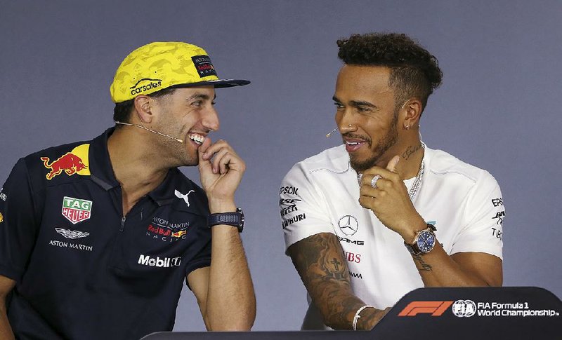 Red Bull driver Daniel Ricciardo of Australia (left) and Mercedes driver Lewis Hamilton of Britain laugh during a news conference Thursday at the Australian Formula One Grand Prix in Melbourne. The first race of the season is Sunday, and Hamilton said this year could be one of the most competitive yet in the sport.
