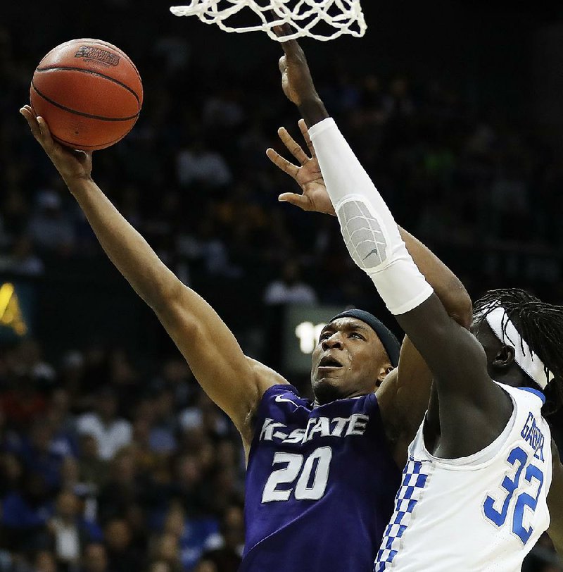 Forward Xavier Sneed (20) goes up for a shot against forward Wenyen Gabriel during Kansas State’s 61-58 victory over Kentucky on Thursday in the South Region semifi nals at Philips Arena in Atlanta.