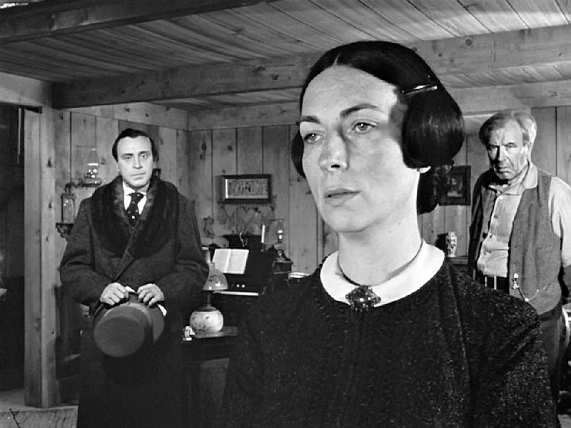 Mary Kane (Agnes Moorehead, center) gets the news from lawyer Walter Thatcher (George Coulouris, left) that she is a millionaire and tells her husband (Harry Shannon, right) that their son will be the beneficiary in Citizen Kane.