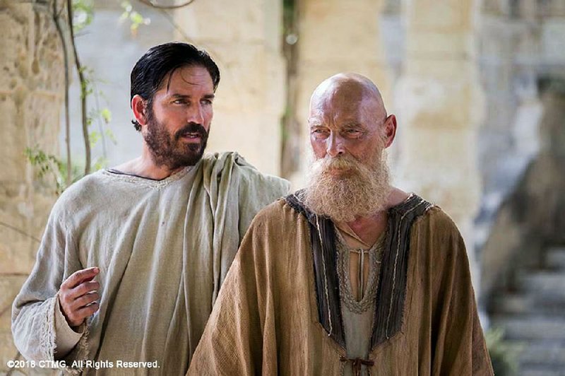 Luke (Jim Caviezel) records the wisdom of the imprisoned Paul (James Faulkner) in Andrew Wyatt’s Paul, Apostle of Christ.
