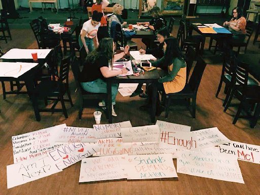 Courtesy Photo/ASHLEA WITT Students and parents craft signs Thursday night at Waterway Christian Church for the March For Our Lives event scheduled for noon today at the Bentonville downtown square.