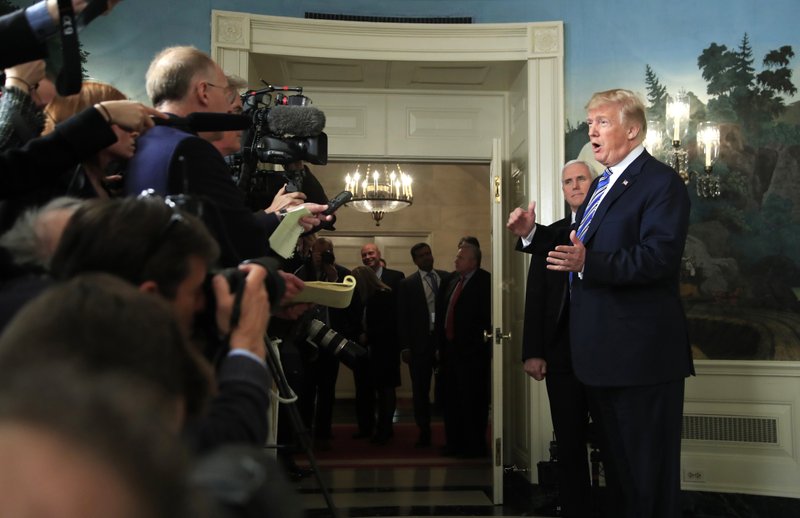 President Donald Trump with, Vice President Mike Pence, responds to reporters' questions in the Diplomatic Room of the White House in Washington, Friday, March 23, 2018, after he spoke about the $1.3 trillion spending bill he signed earlier in the day. (AP Photo/Manuel Balce Ceneta)