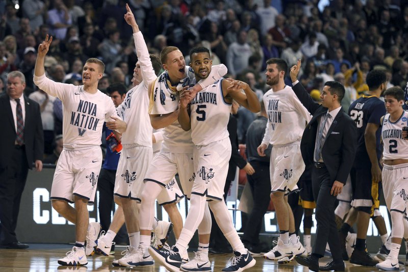 Villanova celebrates a 90-78 win over West Virginia in an NCAA men's college basketball tournament regional semifinal Friday, March 23, 2018, in Boston. (AP Photo/Mary Schwalm)