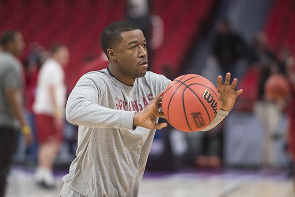 Arkansas assistant coach TJ Cleveland works with players during practice Thursday, March 15, 2018, at Little Caesars Arena in Detroit. 